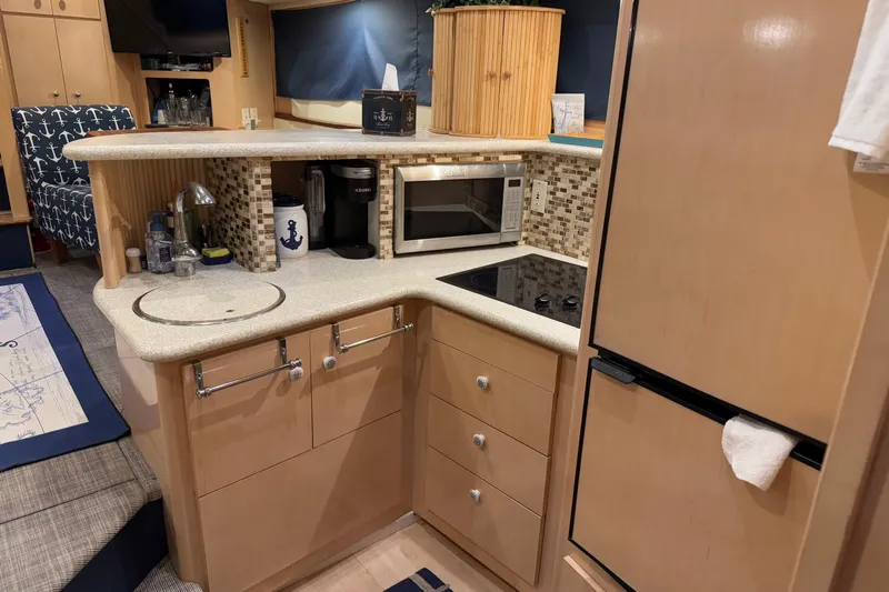 Allegedly Yacht Photos Pics Interior of 2000 Carver 396 Motor Yacht kitchen with modern appliances and nautical decor.