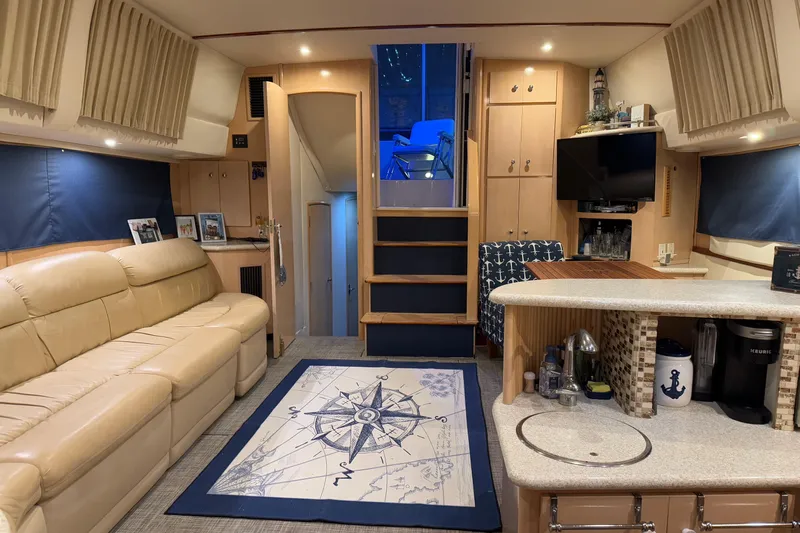 Allegedly Yacht Photos Pics Luxurious interior of 2000 Carver 396 Motor Yacht with cozy seating and nautical decor.
