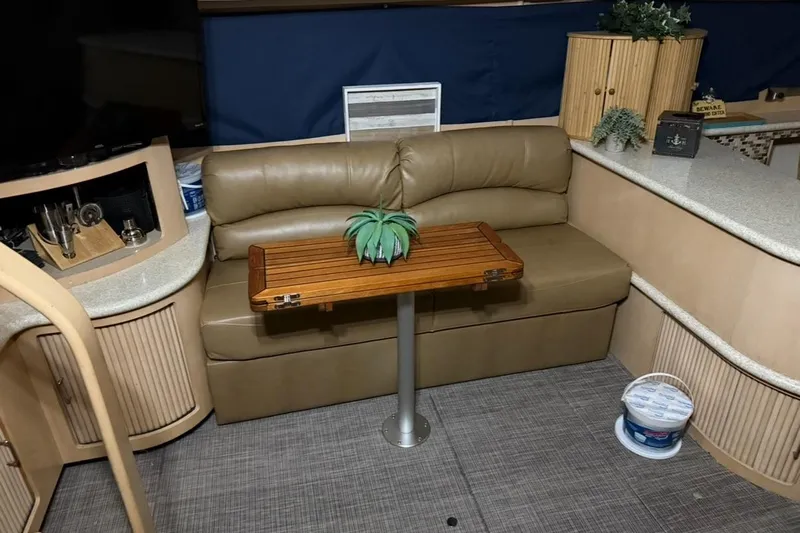 Allegedly Yacht Photos Pics Interior of 2000 Carver 396 Motor Yacht with leather seating and wooden table.