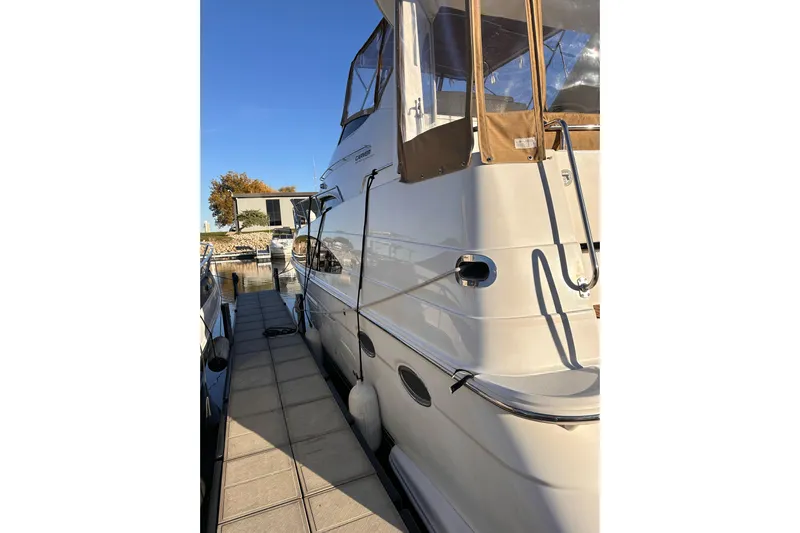 Allegedly Yacht Photos Pics 2000 Carver 396 Motor Yacht docked at marina under clear blue sky.