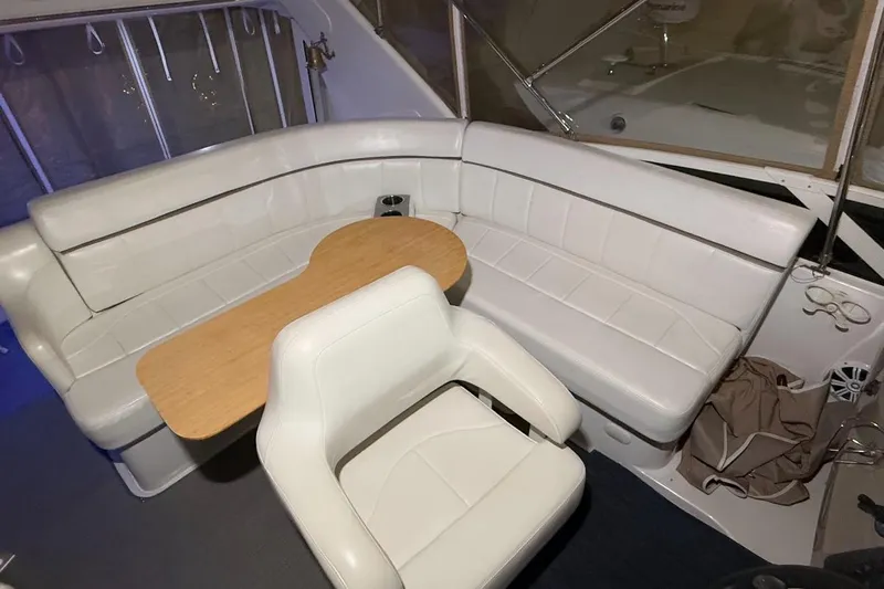 Allegedly Yacht Photos Pics 2000 Carver 396 Motor Yacht interior with white seating and wooden table.