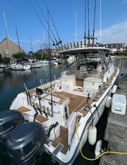  Yacht Photos Pics 2003 Grady-White Express 330 boat docked, equipped with Yamaha engines and fishing rods.