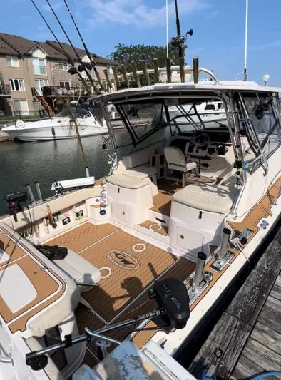  Yacht Photos Pics 2003 Grady-White Express 330 boat docked, featuring fishing rods and spacious seating.