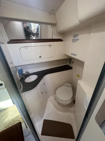  Yacht Photos Pics 2003 Grady-White Express 330 boat bathroom with sink, toilet, and storage.