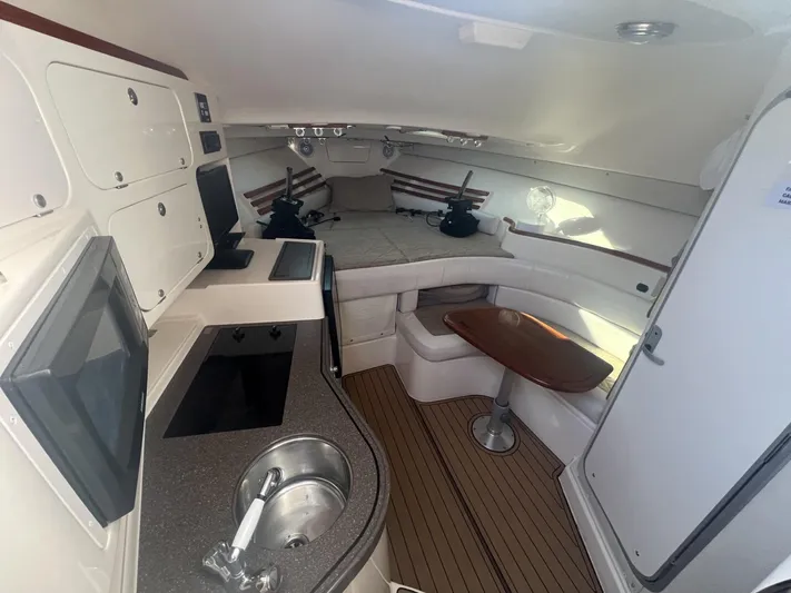  Yacht Photos Pics 2003 Grady-White Express 330 cabin interior with kitchenette, seating, and sleeping area.