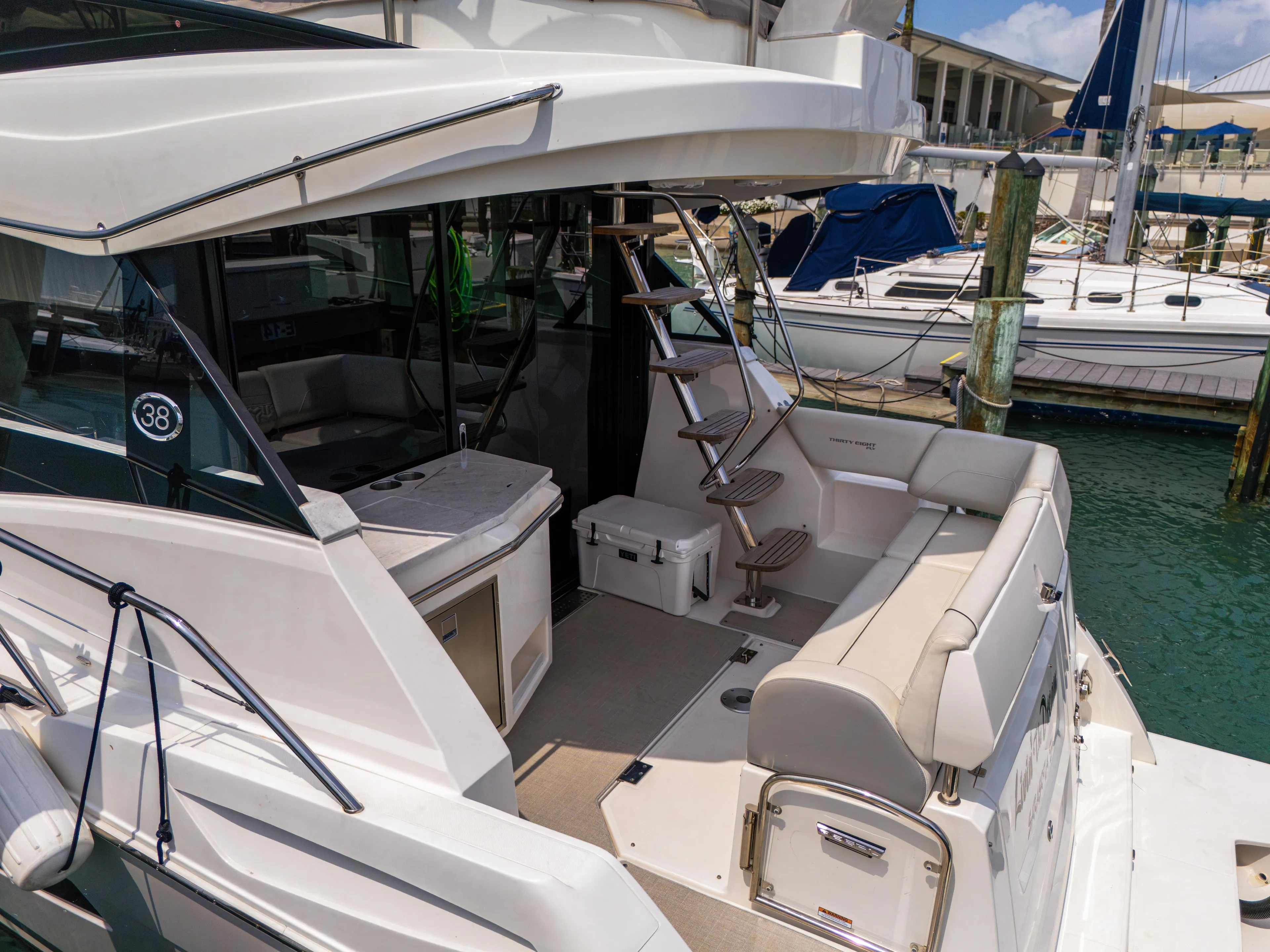  Yacht Photos Pics 2023 Regal 38 FXO yacht interior with seating and dock view.