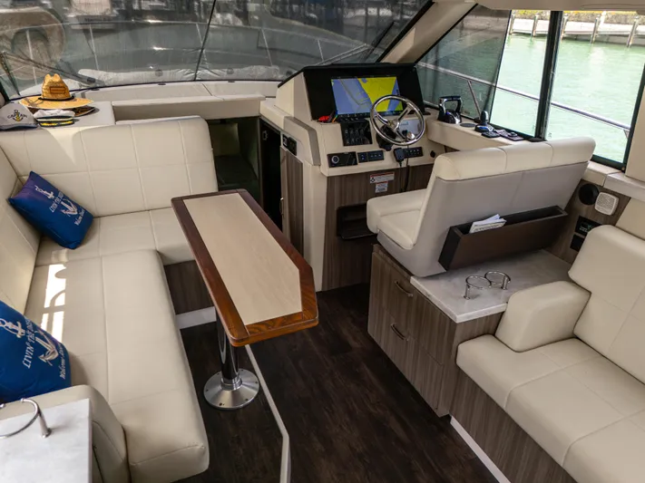  Yacht Photos Pics Luxurious interior of 2023 Regal 38 FXO yacht with modern seating and navigation controls.