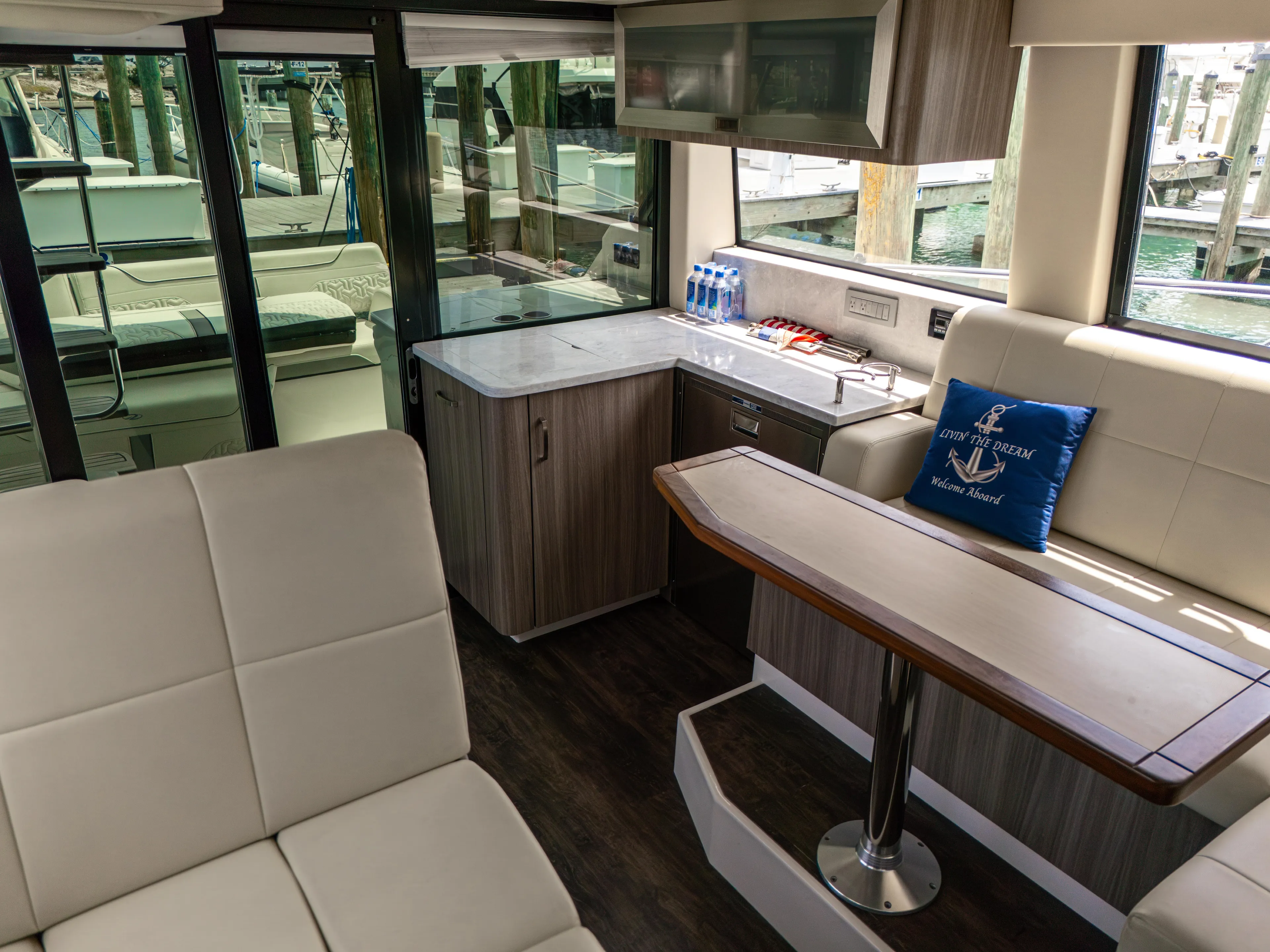  Yacht Photos Pics Interior of 2023 Regal 38 FXO yacht with modern seating and kitchenette.