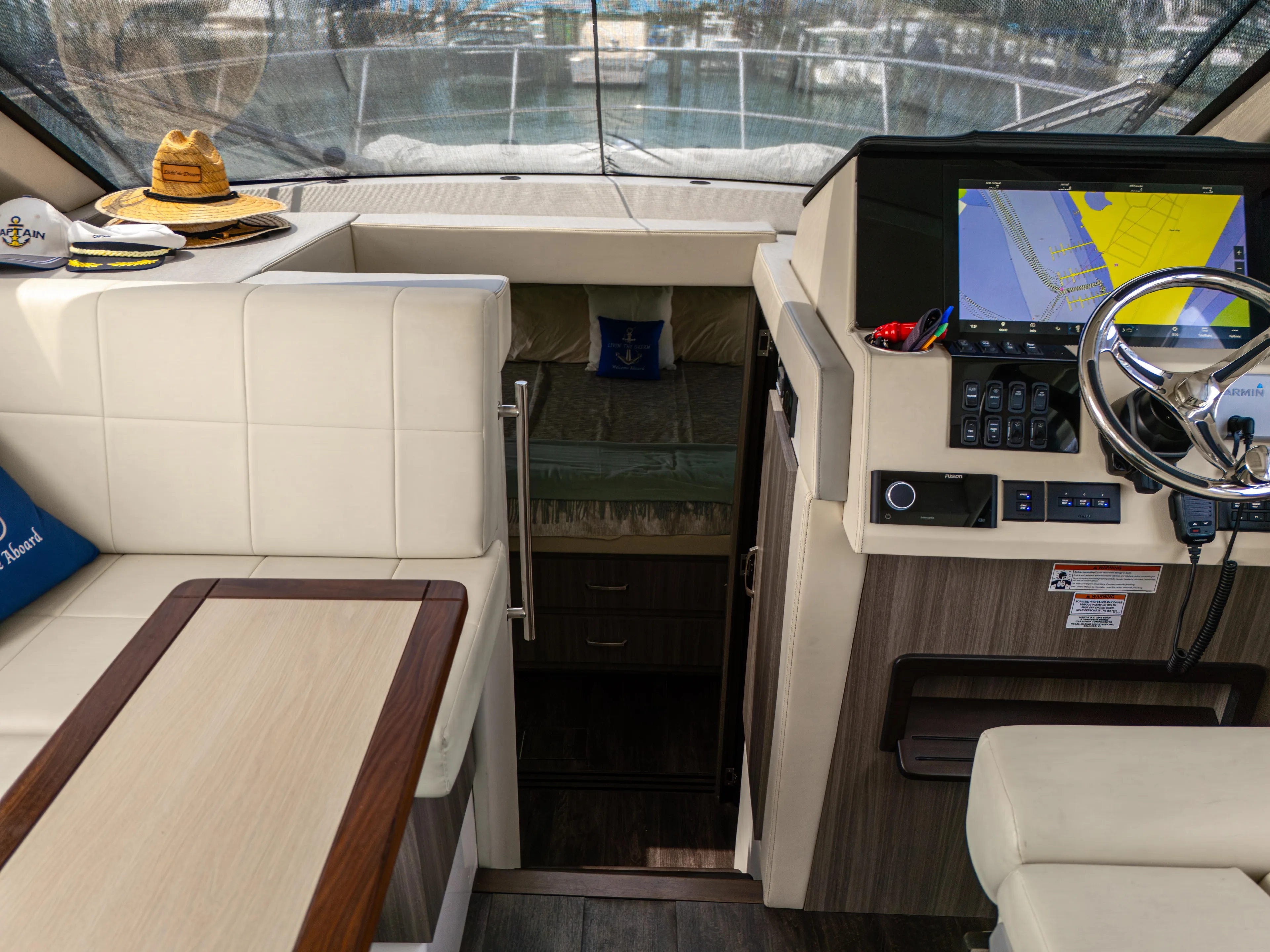  Yacht Photos Pics 2023 Regal 38 FXO yacht interior with helm, seating, and navigation display.