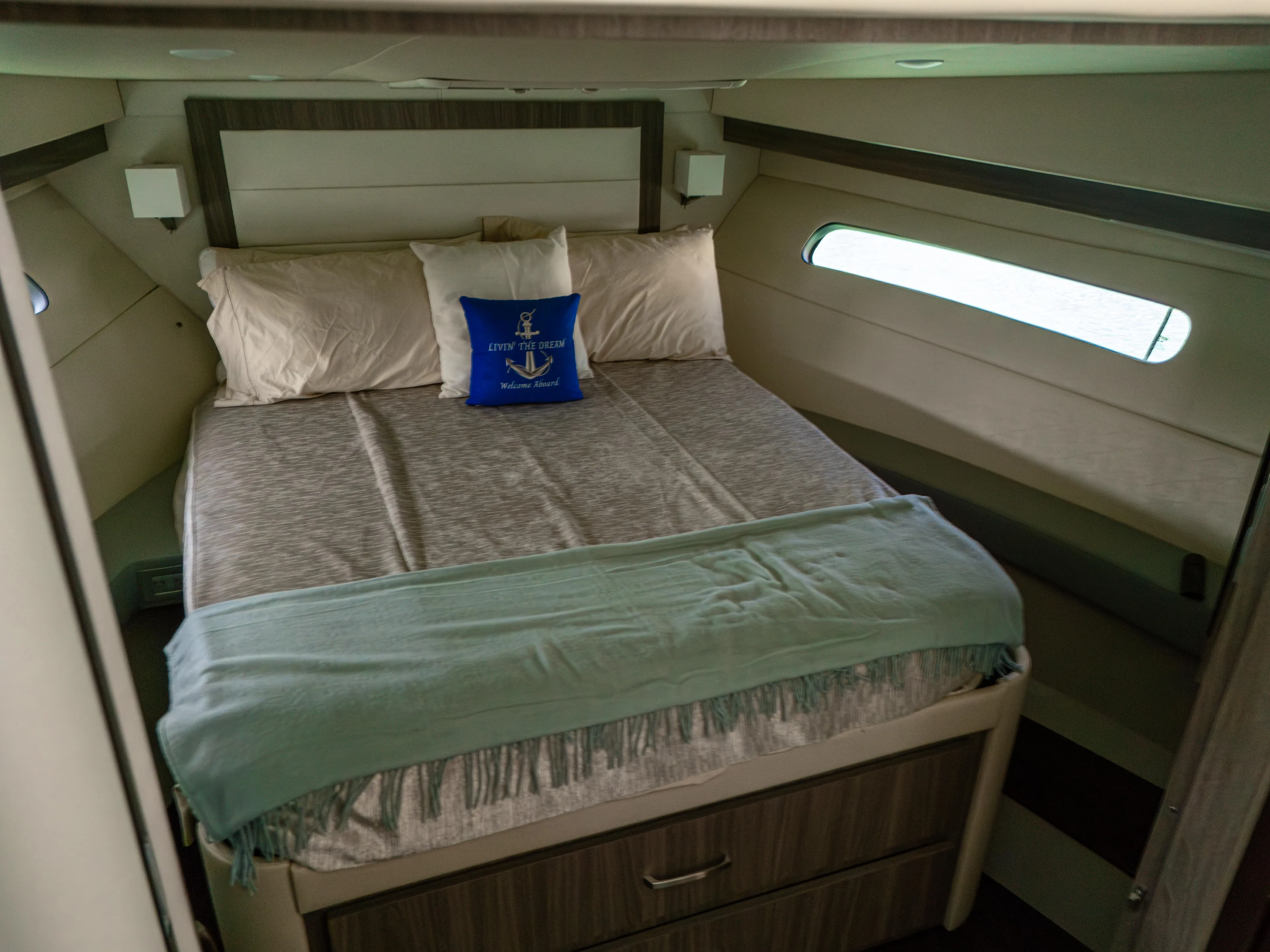  Yacht Photos Pics 2023 Regal 38 FXO cabin interior with cozy bed and nautical-themed decor.