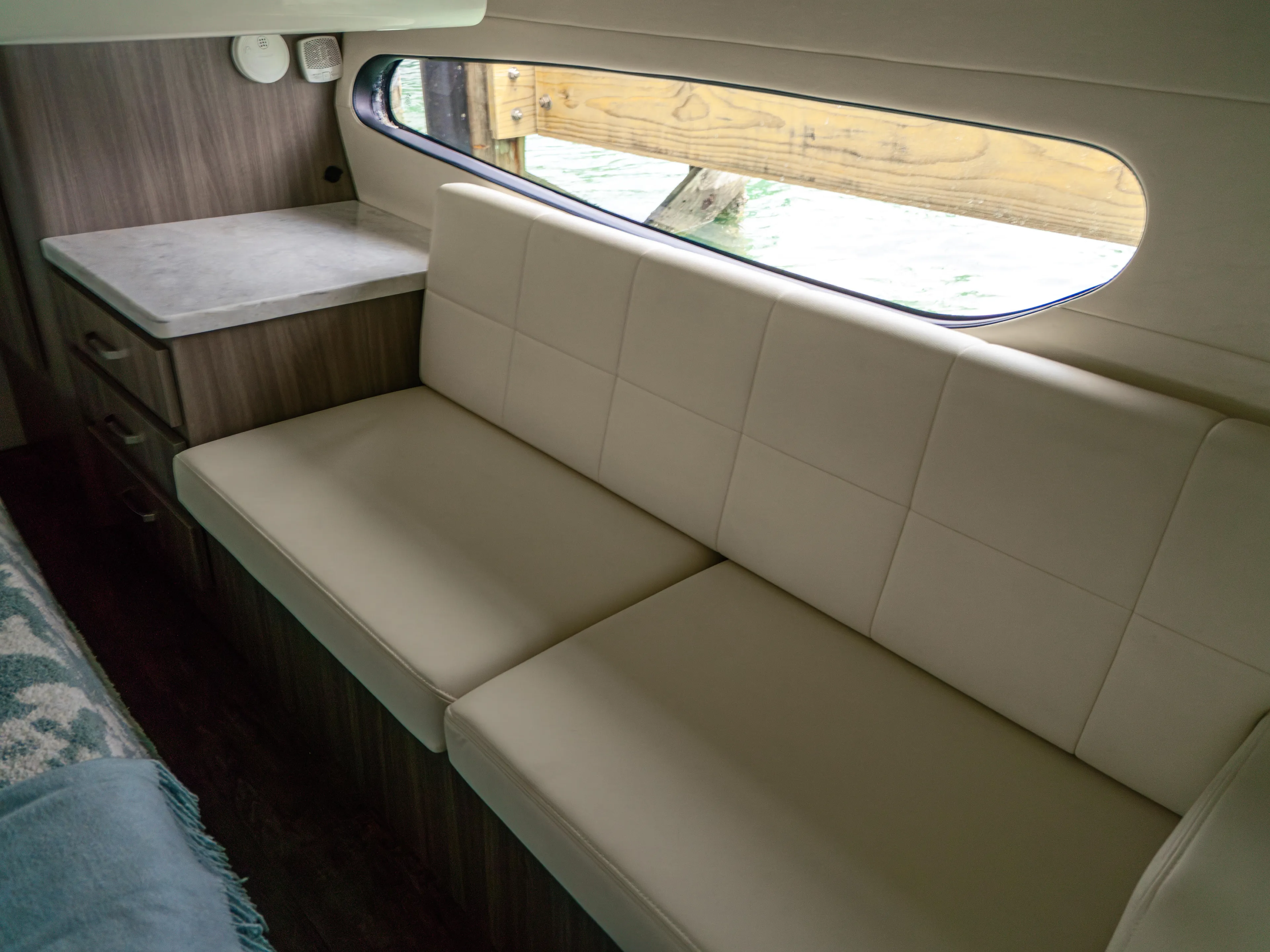  Yacht Photos Pics Interior of 2023 Regal 38 FXO yacht with beige seating and wooden accents.