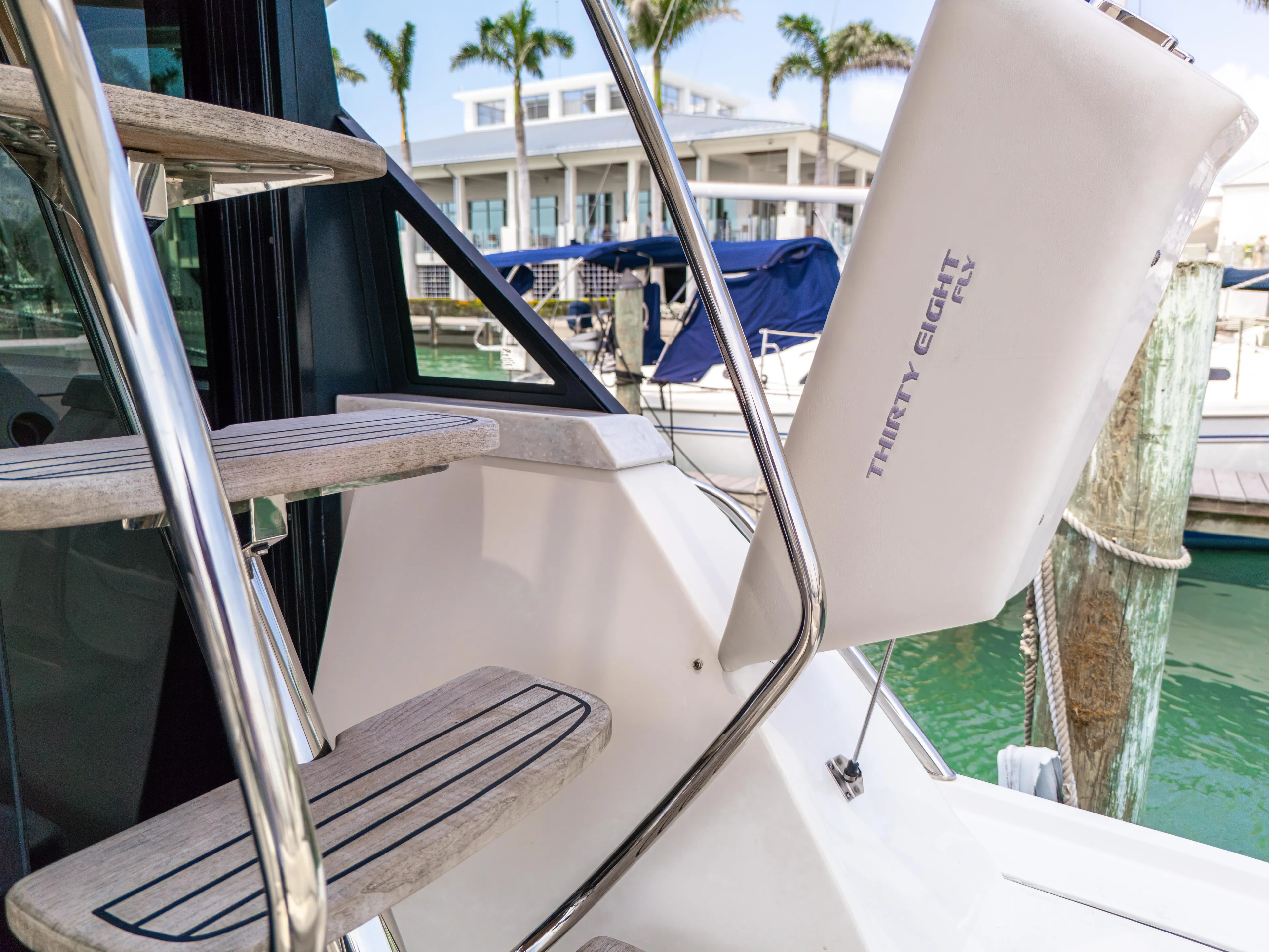  Yacht Photos Pics Staircase on 2023 Regal 38 FXO yacht with marina backdrop.
