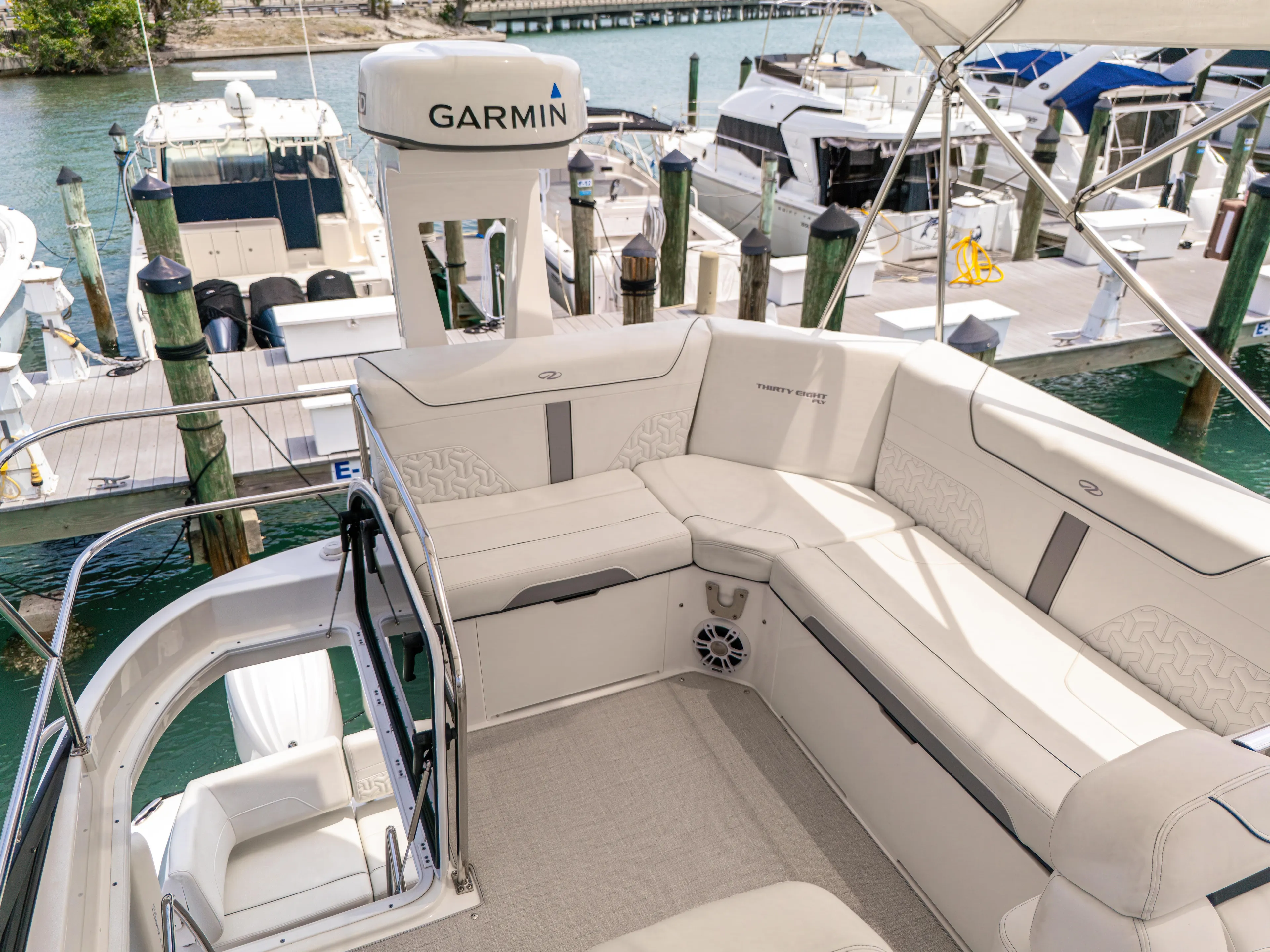  Yacht Photos Pics 2023 Regal 38 FXO yacht with spacious seating and Garmin navigation at marina.