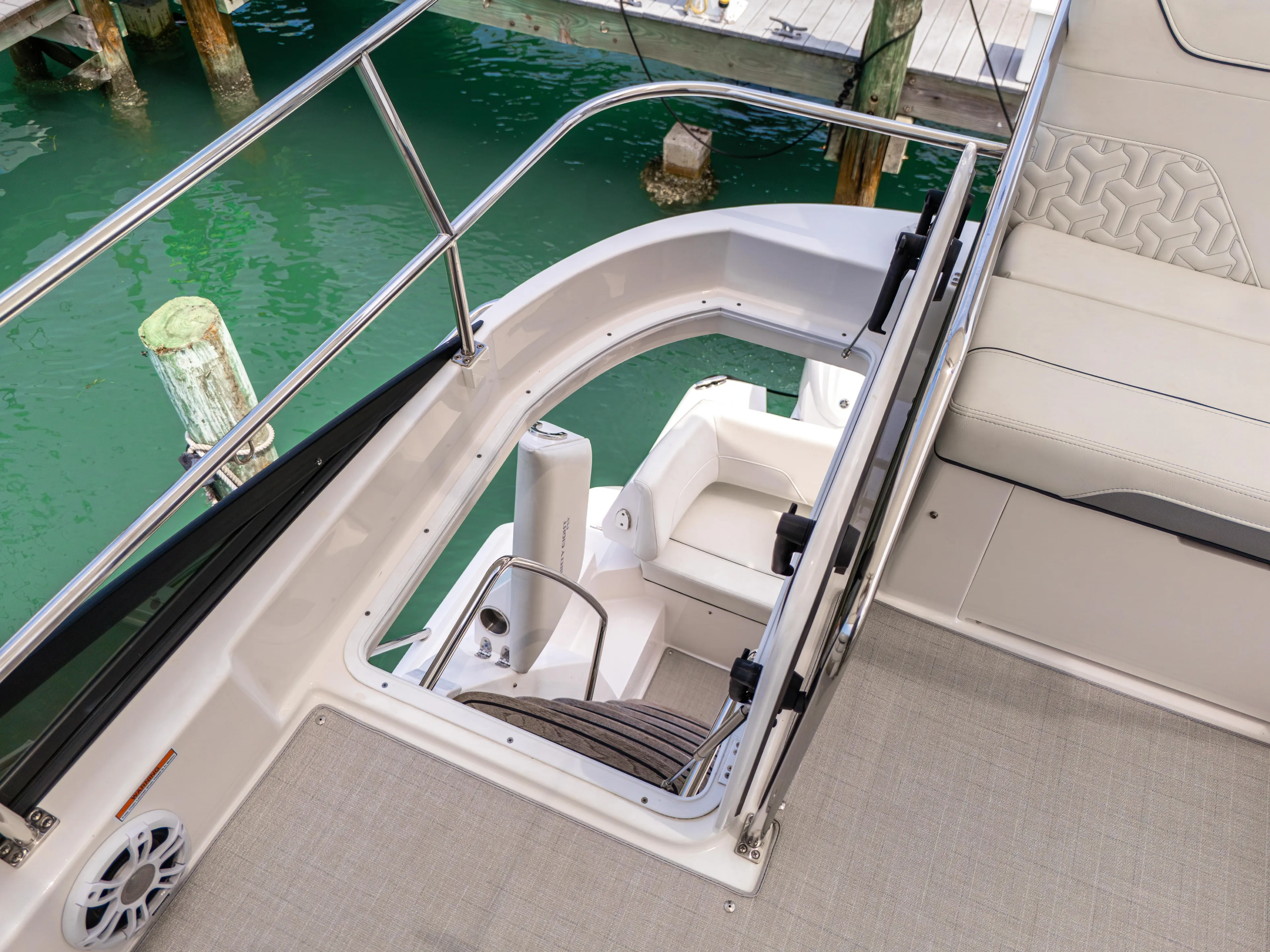  Yacht Photos Pics 2023 Regal 38 FXO boat interior with stairs and seating, dockside view.