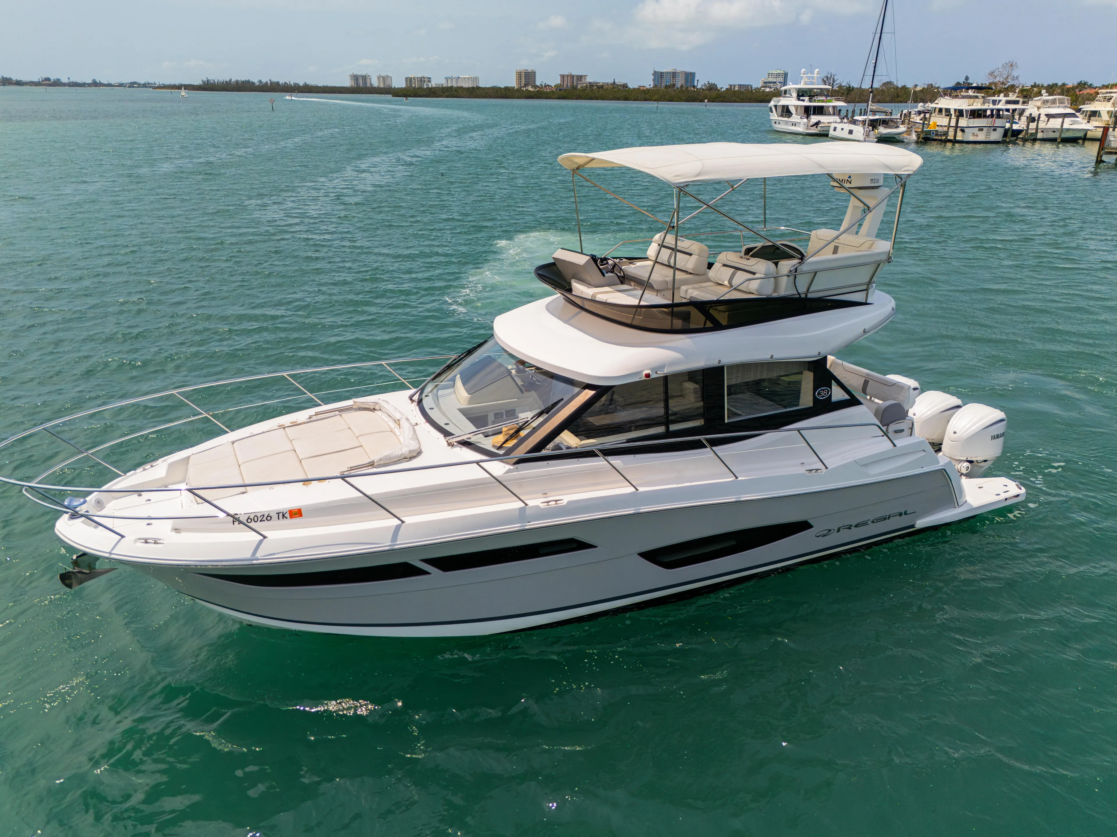  Yacht Photos Pics 2023 Regal 38 FXO yacht cruising on clear blue water.