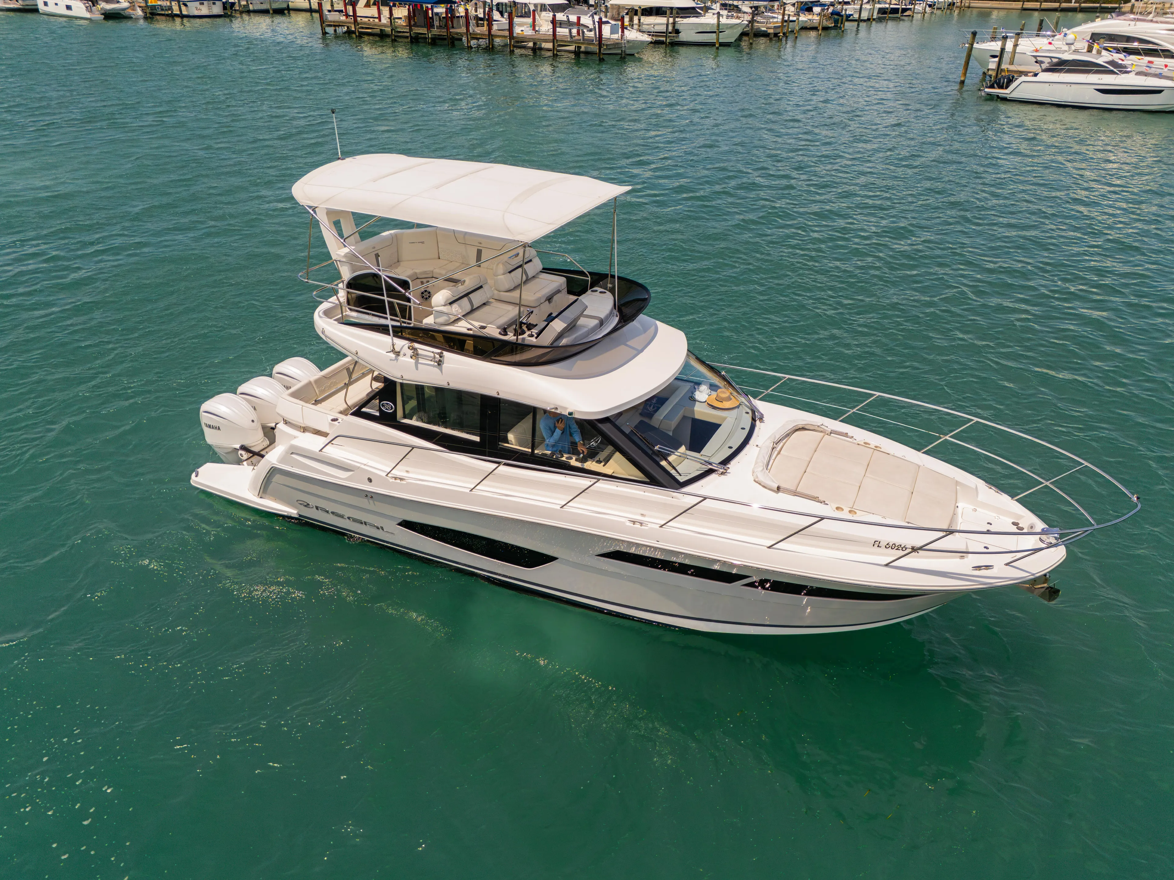  Yacht Photos Pics 2023 Regal 38 FXO yacht cruising on clear turquoise water.