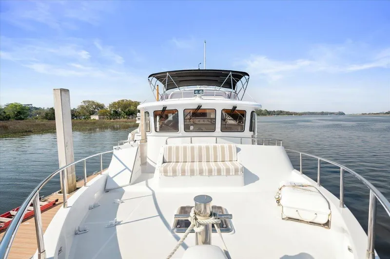  Yacht Photos Pics Selene 53 yacht from 2003 on calm water, featuring spacious deck and seating area.