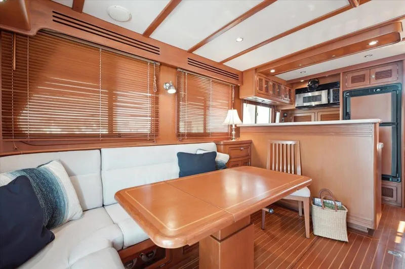  Yacht Photos Pics Luxurious interior of 2003 Selene 53 yacht with wooden furnishings and cozy seating area.