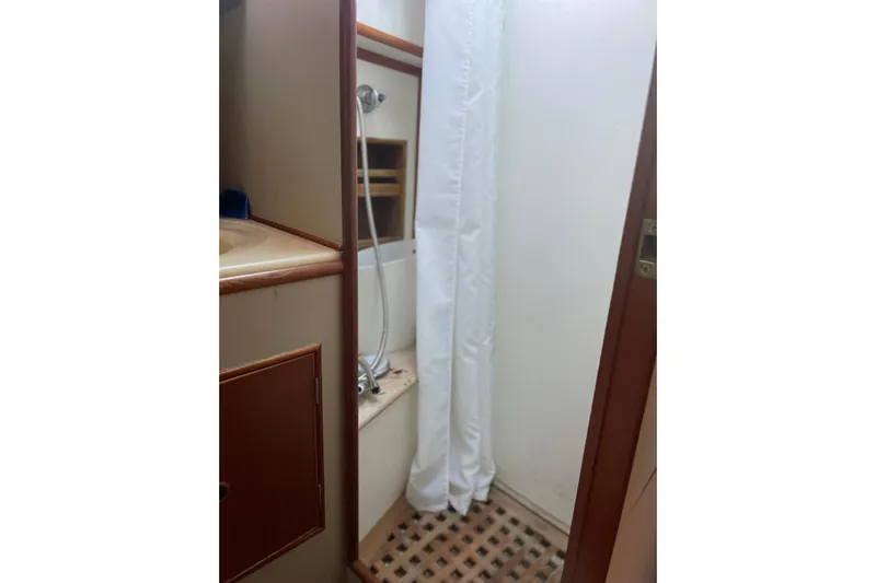  Yacht Photos Pics Bathroom interior of 1987 Grand Banks 42 Motoryacht with shower and wooden accents.