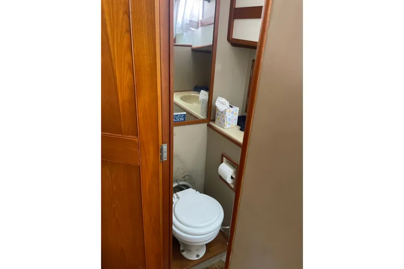  Yacht Photos Pics Bathroom interior of 1987 Grand Banks 42 Motoryacht with wooden cabinetry and compact design.