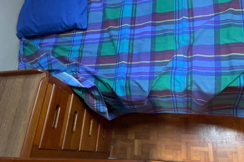  Yacht Photos Pics Plaid bedspread and wooden drawers on a 1987 Grand Banks 42 Motoryacht.