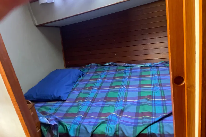  Yacht Photos Pics Cozy cabin bed with plaid bedding on 1987 Grand Banks 42 Motoryacht.