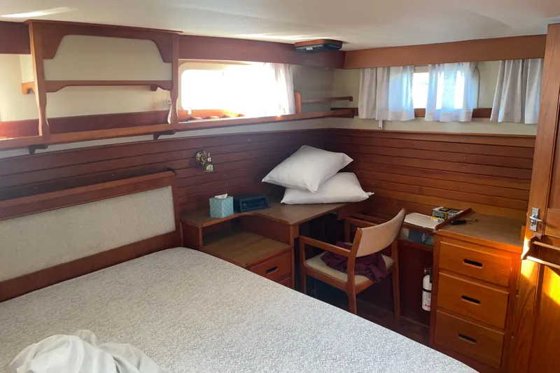  Yacht Photos Pics Cozy cabin interior of 1987 Grand Banks 42 Motoryacht with wooden furnishings and natural light.