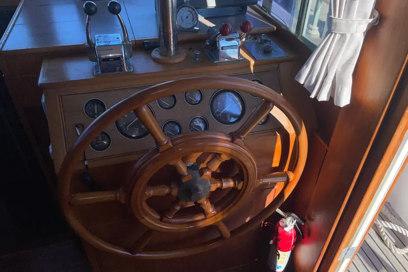  Yacht Photos Pics Wooden helm of a 1987 Grand Banks 42 Motoryacht with gauges and controls.