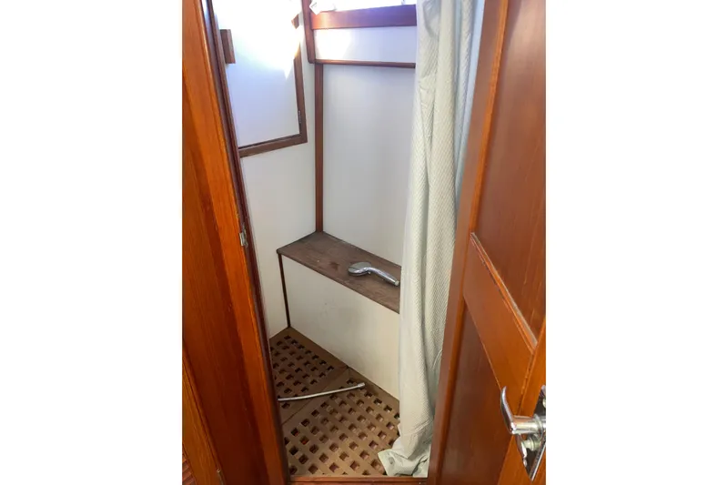  Yacht Photos Pics Shower area in 1987 Grand Banks 42 Motoryacht with wooden accents and curtain.
