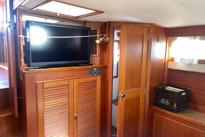  Yacht Photos Pics Interior of 1987 Grand Banks 42 Motoryacht with wooden cabinetry and mounted TV.