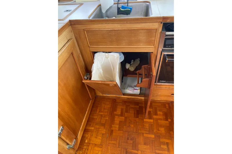  Yacht Photos Pics Wooden kitchen cabinet with trash bin in 1987 Grand Banks 42 Motoryacht.