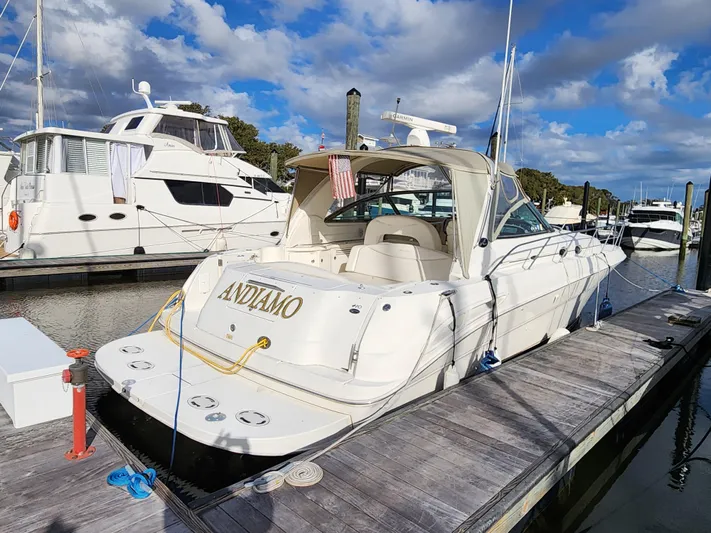  Yacht Photos Pics 2001 Sea Ray 410 Express Cruiser docked at marina under blue sky.