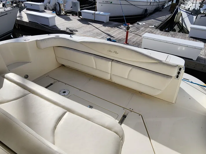  Yacht Photos Pics 2001 Sea Ray 410 Express Cruiser interior with white seating at a marina.