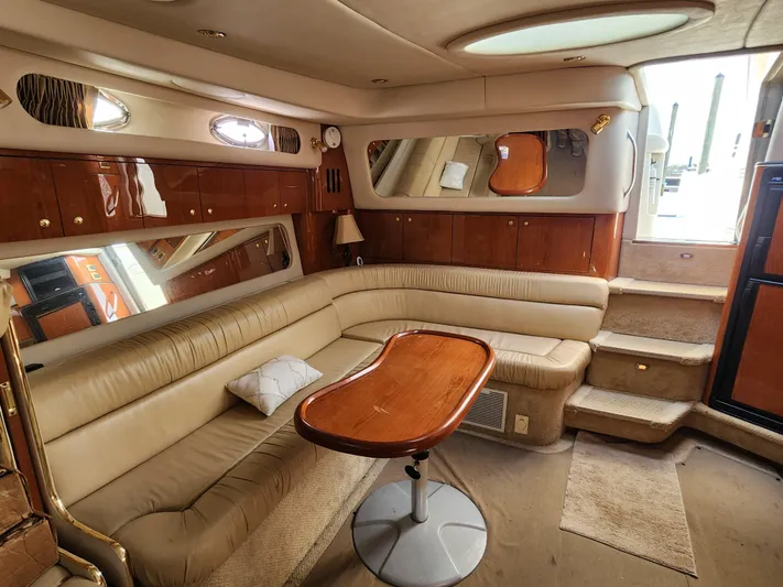  Yacht Photos Pics Luxurious interior of 2001 Sea Ray 410 Express Cruiser with plush seating and wooden accents.