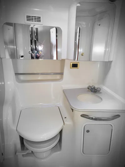  Yacht Photos Pics 2001 Sea Ray 410 Express Cruiser bathroom with toilet, sink, and mirrored cabinet.