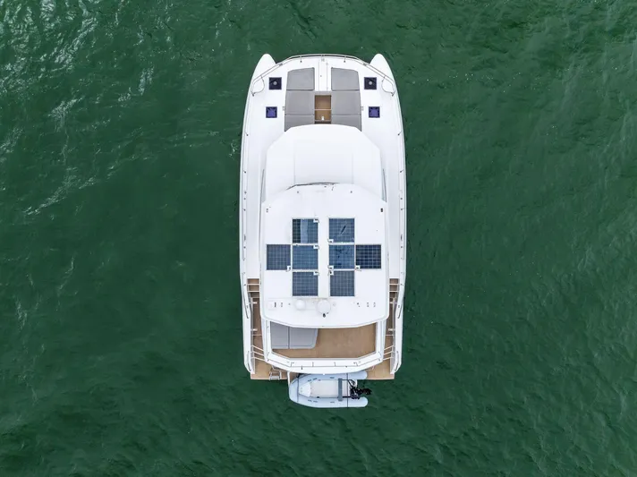 53 Powercat Yacht Photos Pics Aerial view of 2021 Leopard 53 Powercat yacht with solar panels on green water.