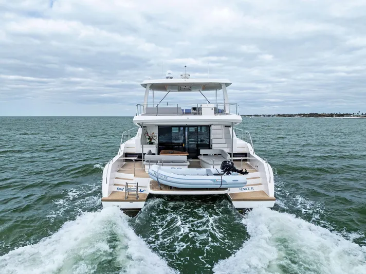 53 Powercat Yacht Photos Pics 2021 Leopard 53 Powercat cruising on open water, rear view.