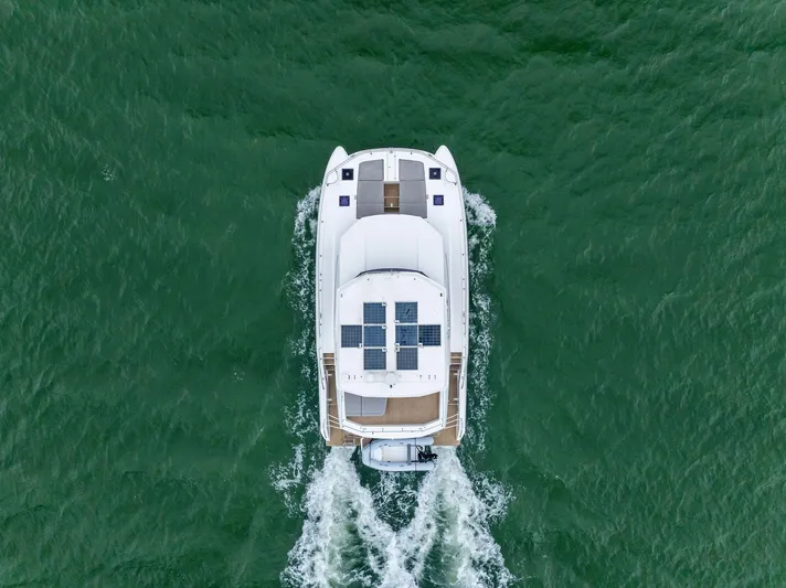 53 Powercat Yacht Photos Pics Aerial view of 2021 Leopard 53 Powercat cruising on green water.