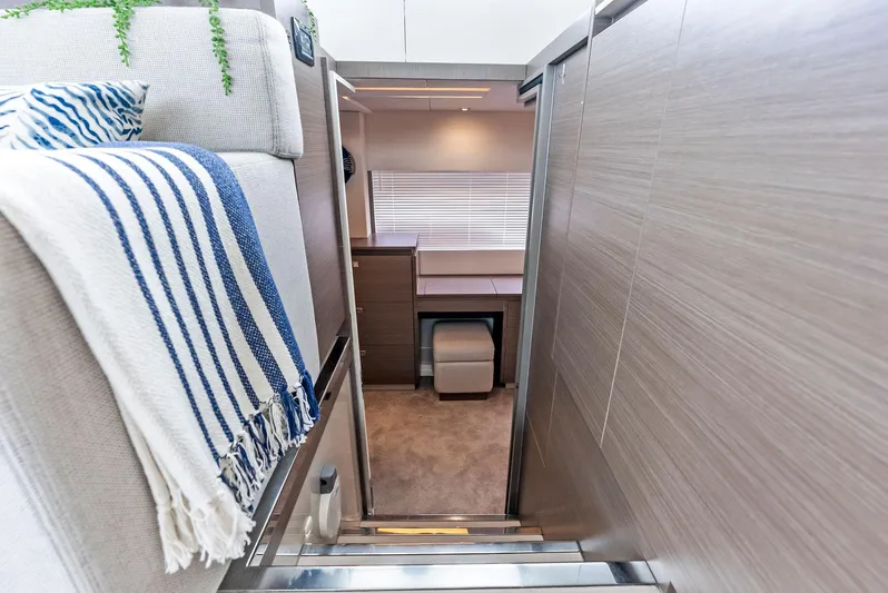 53 Powercat Yacht Photos Pics Interior of 2021 Leopard 53 Powercat, featuring cozy cabin with modern decor and striped blanket.