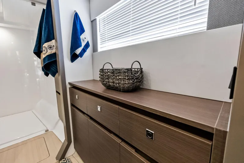 53 Powercat Yacht Photos Pics Interior of 2021 Leopard 53 Powercat with wooden cabinetry and decorative basket.