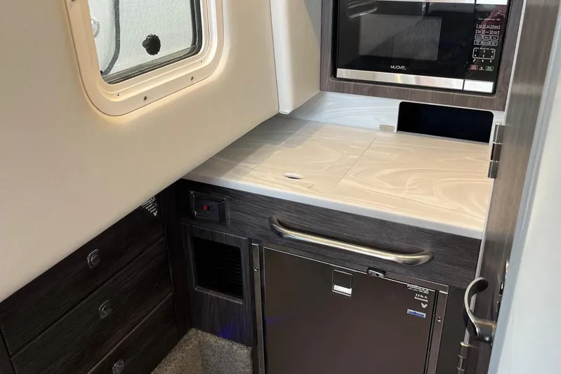  Yacht Photos Pics 2020 Formula 350 Crossover Bowrider interior with kitchenette, featuring microwave and storage.