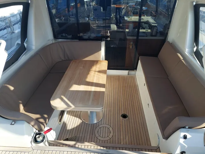  Yacht Photos Pics Luxurious seating area on a 2016 Moody 54 DS yacht with wooden table and cushioned benches.