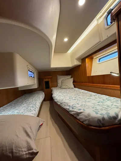  Yacht Photos Pics Cozy cabin interior of 2016 Moody 54 DS yacht with twin beds and wooden accents.