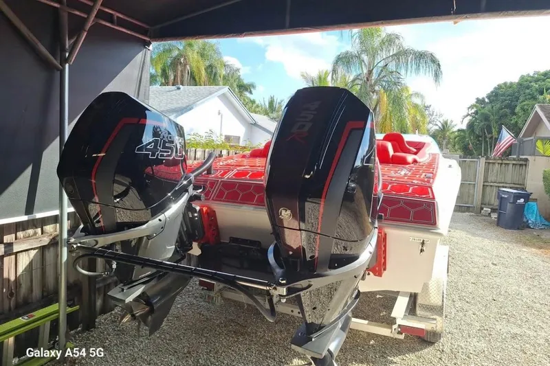  Yacht Photos Pics 2020 HellKats 30 boat with dual 450R engines, parked outdoors under a canopy.