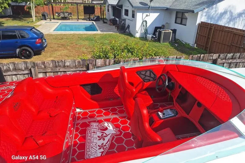  Yacht Photos Pics Red interior of 2020 HellKats 30 powerboat with pool and car in background.