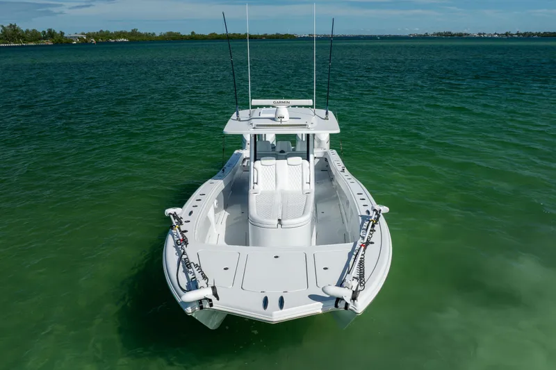  Yacht Photos Pics 2024 Costa Custom Boats 34 SV on calm green water, showcasing sleek design and fishing equipment.