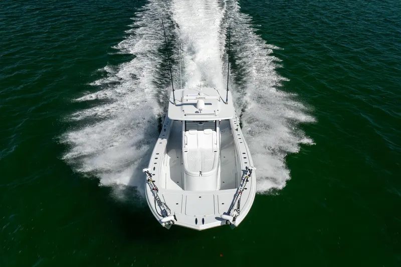  Yacht Photos Pics 2024 Costa Custom Boats 34 SV cruising swiftly on open water.
