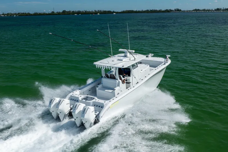  Yacht Photos Pics 2024 Costa Custom Boats 34 SV cruising on open water with triple outboard engines.