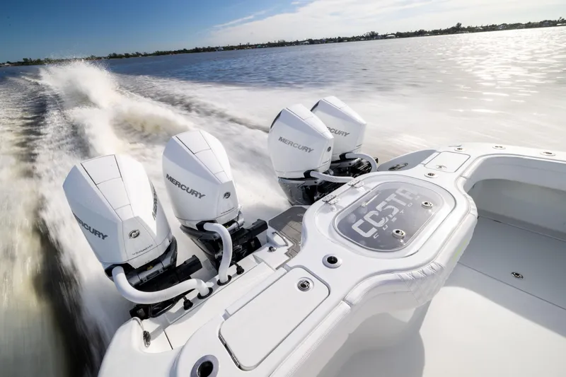  Yacht Photos Pics 2024 Costa Custom Boats 34 SV with triple Mercury engines cruising on water.