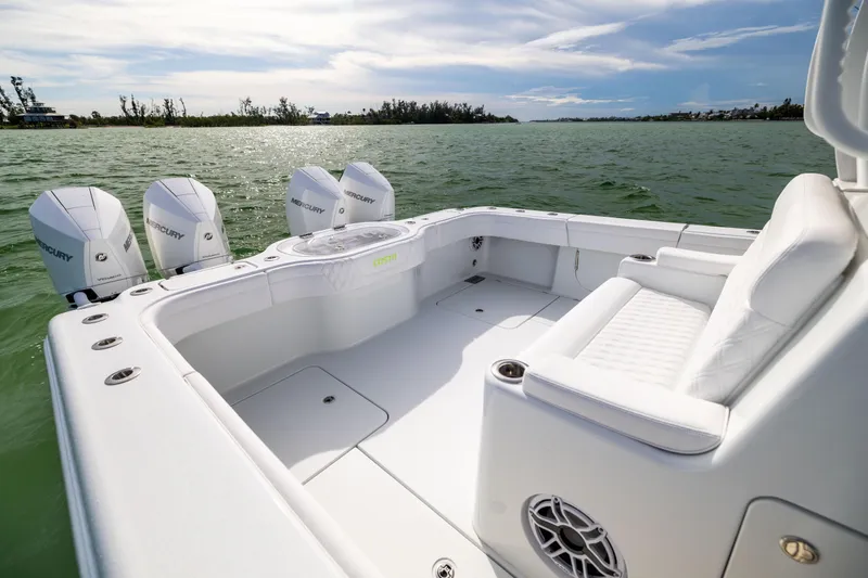  Yacht Photos Pics 2024 Costa Custom Boats 34 SV, spacious deck with four Mercury engines, on calm water.